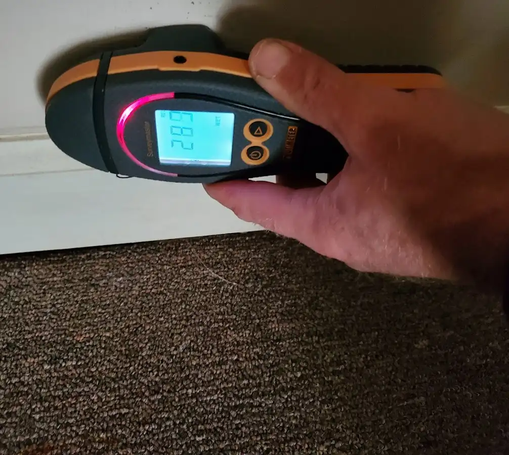 Moisture detection at baseboard during Storm Damage Restoration in Hartford City